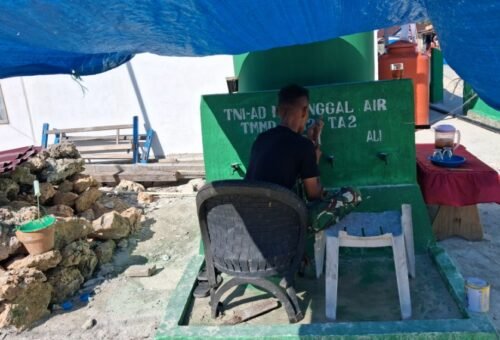 Pengecatan Logo TMMD Sebagai Identitas Program di Manunggal Air Bersih