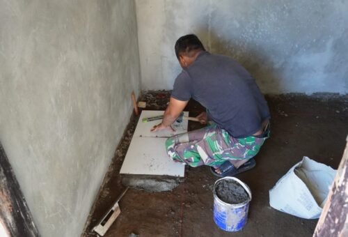 Pemasangan Keramik RTLH Ibu Nengah Madri, Proyek TMMD Ke-129 Berjalan Lancar